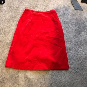 Red mid length skirt. Suede like material.